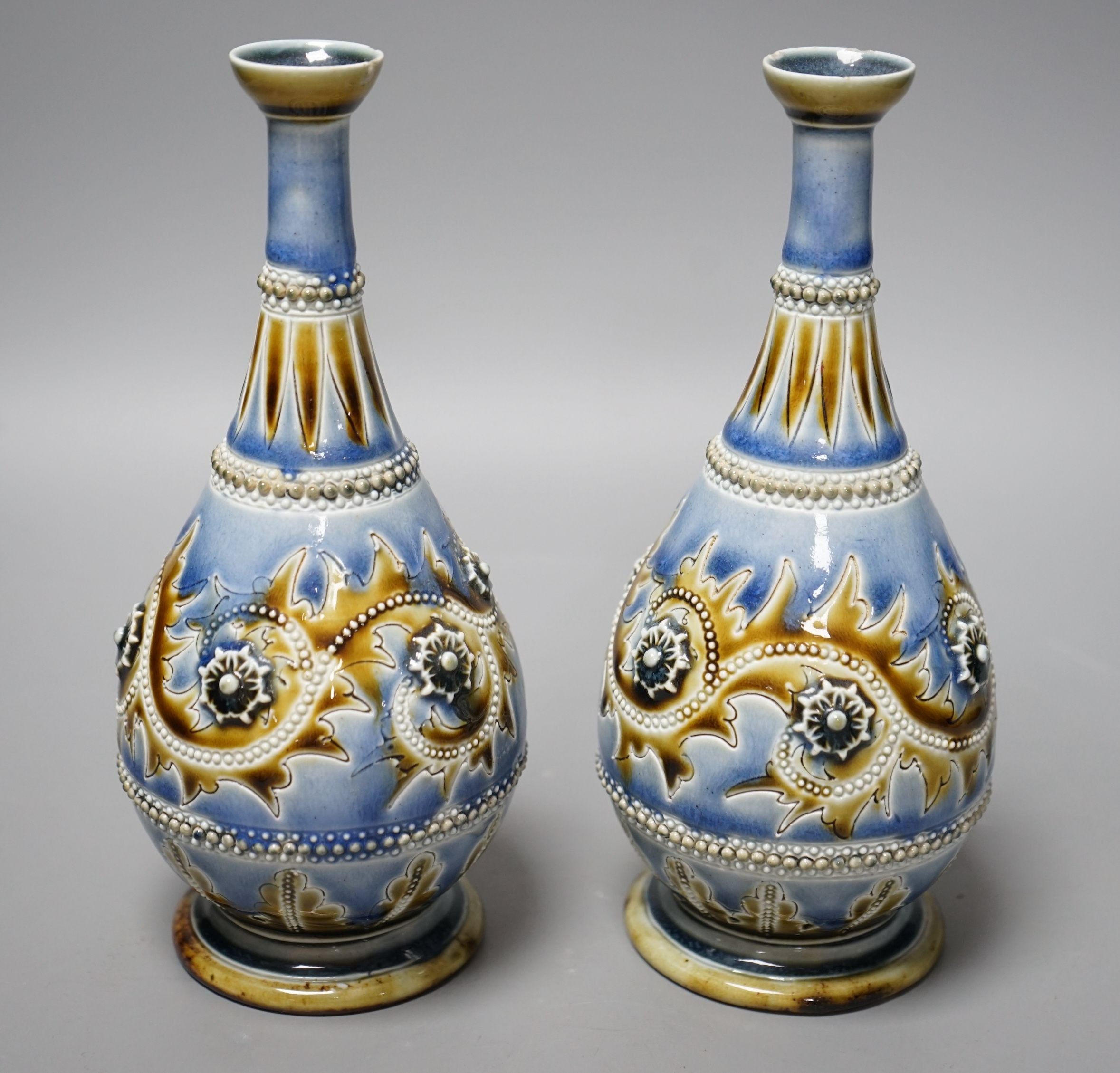 George Tinworth, a pair of Doulton Lambeth vases, stamped 1876, 20cm high